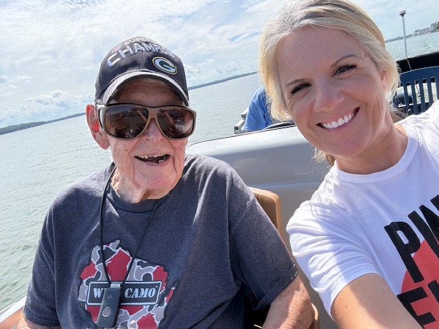 A Caring Companion client and caregiver enjoying a sunny boat outing together